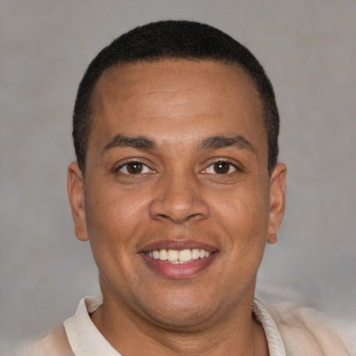 Joyful latino adult male with short  brown hair and brown eyes