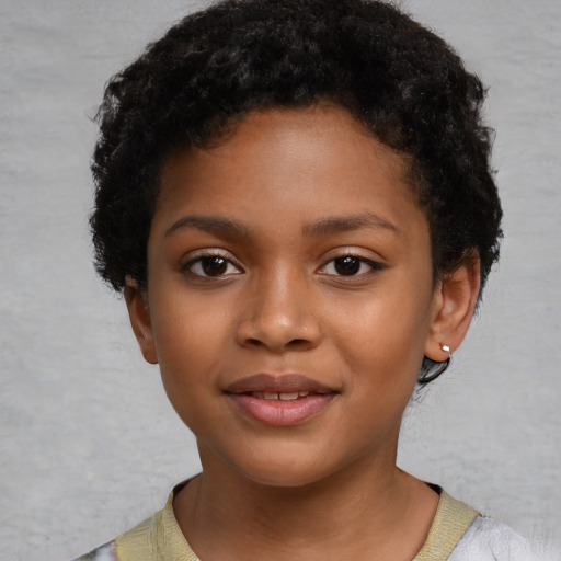 Joyful black child female with short  brown hair and brown eyes