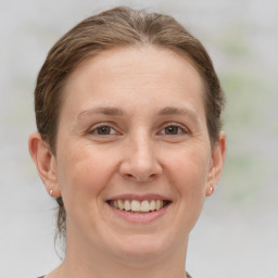 Joyful white young-adult female with short  brown hair and grey eyes