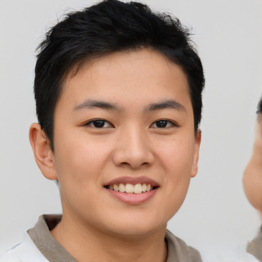Joyful asian young-adult male with short  brown hair and brown eyes