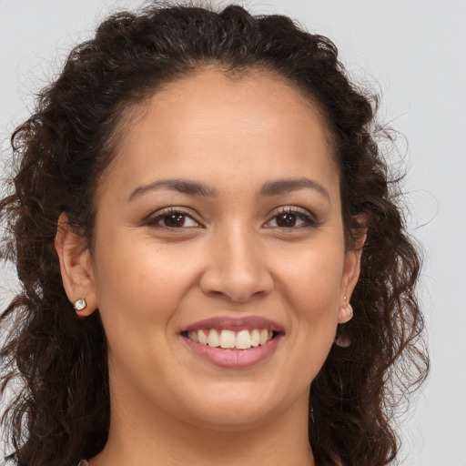 Joyful white young-adult female with long  brown hair and brown eyes