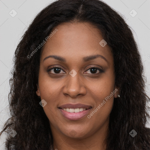 Joyful black young-adult female with long  brown hair and brown eyes