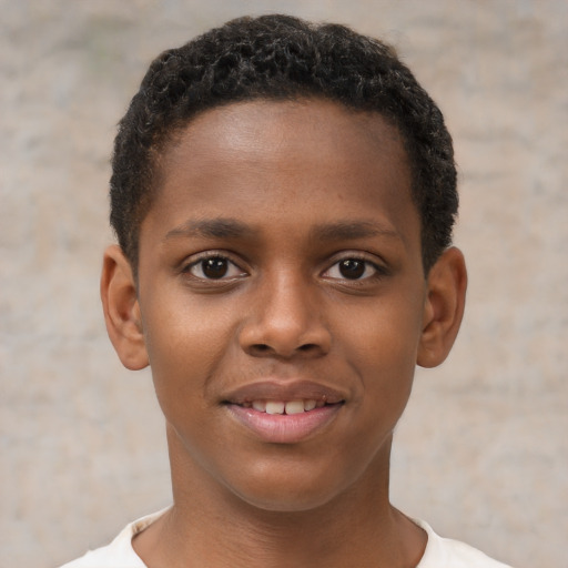 Joyful black child male with short  brown hair and brown eyes