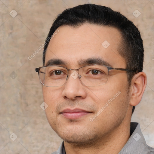 Joyful white adult male with short  black hair and brown eyes