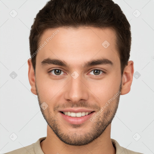 Joyful white young-adult male with short  brown hair and brown eyes