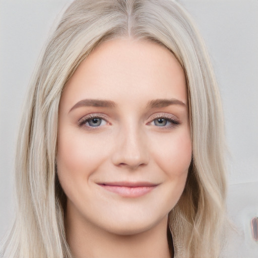 Joyful white young-adult female with long  brown hair and blue eyes