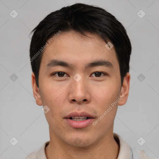 Joyful asian young-adult male with short  brown hair and brown eyes