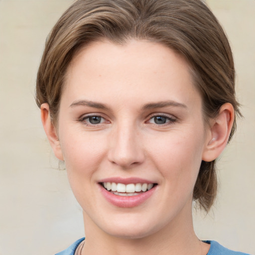 Joyful white young-adult female with medium  brown hair and blue eyes