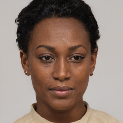 Joyful black young-adult female with short  black hair and brown eyes