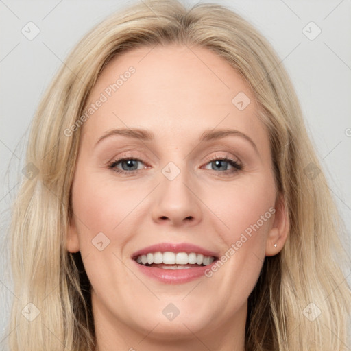 Joyful white young-adult female with long  brown hair and blue eyes