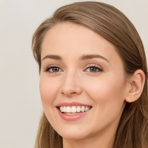 Joyful white young-adult female with long  brown hair and green eyes