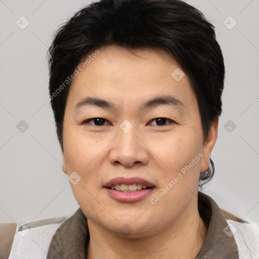 Joyful asian adult female with short  brown hair and brown eyes