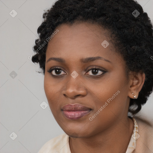 Joyful black young-adult female with long  black hair and brown eyes