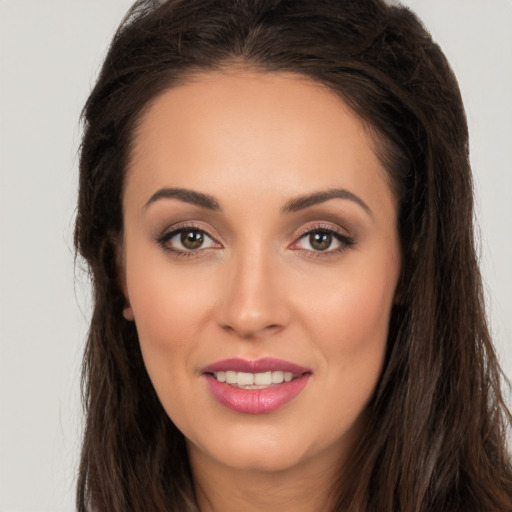 Joyful white young-adult female with long  brown hair and brown eyes