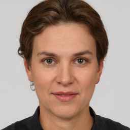 Joyful white adult female with short  brown hair and grey eyes