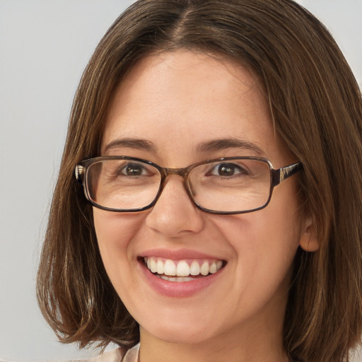 Joyful white young-adult female with medium  brown hair and green eyes