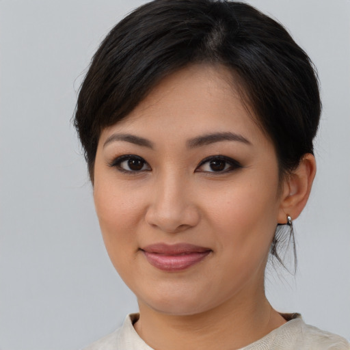 Joyful asian young-adult female with medium  brown hair and brown eyes