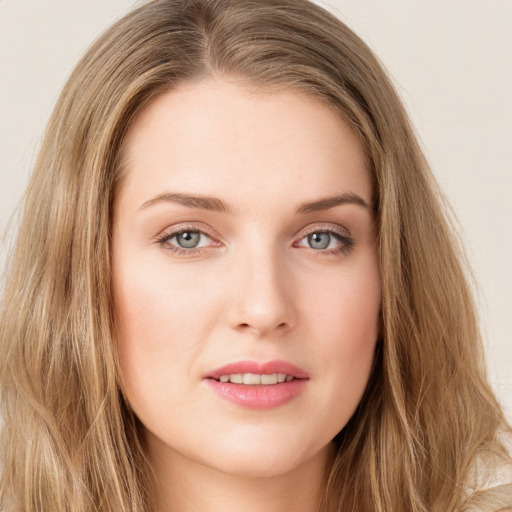 Joyful white young-adult female with long  brown hair and green eyes