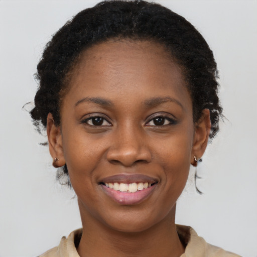 Joyful black young-adult female with long  brown hair and brown eyes