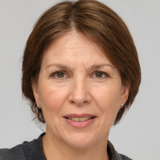 Joyful white adult female with medium  brown hair and grey eyes