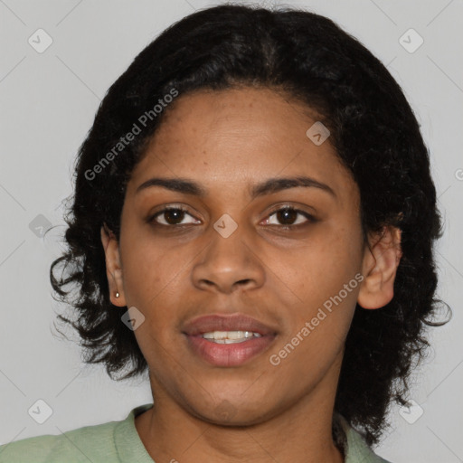 Joyful black young-adult female with short  black hair and brown eyes