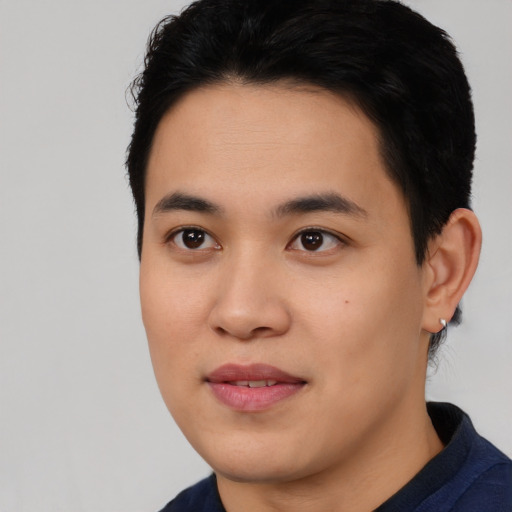 Joyful asian young-adult male with short  black hair and brown eyes