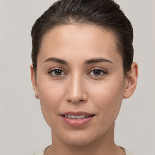 Joyful white young-adult female with short  brown hair and brown eyes