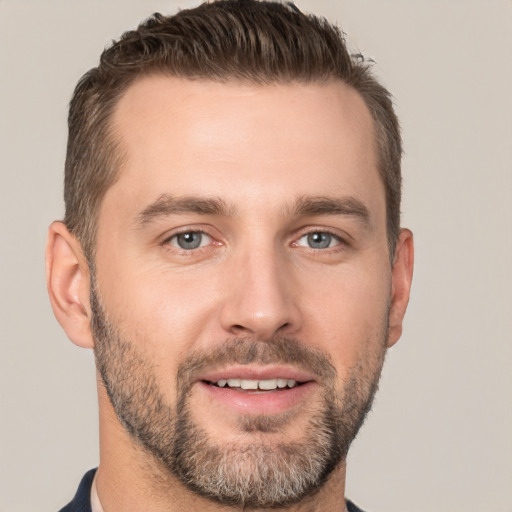 Joyful white young-adult male with short  brown hair and brown eyes