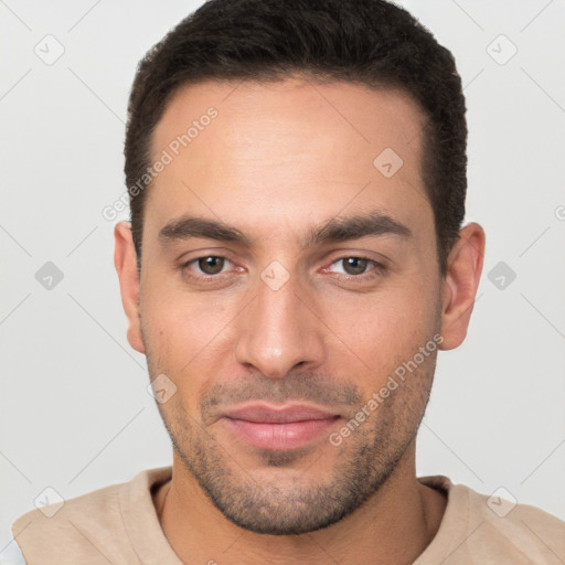 Joyful white young-adult male with short  brown hair and brown eyes