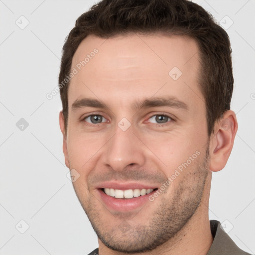 Joyful white young-adult male with short  brown hair and brown eyes