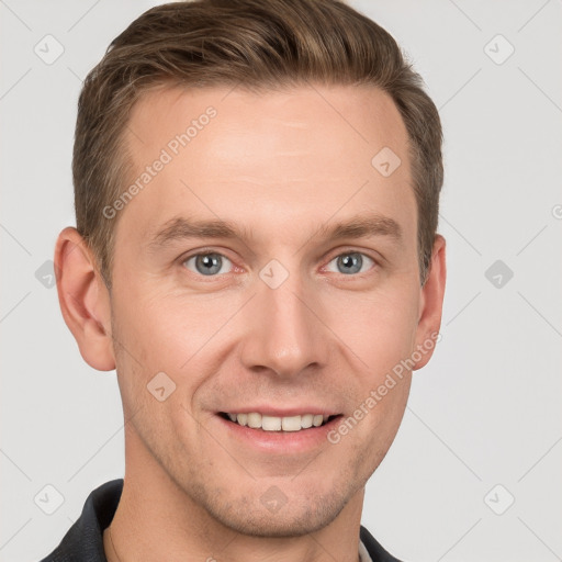 Joyful white young-adult male with short  brown hair and grey eyes