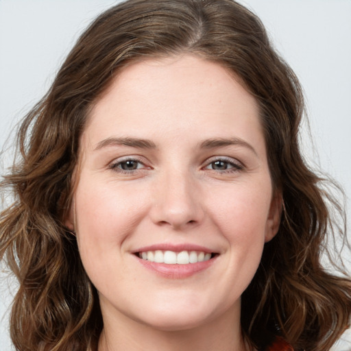 Joyful white young-adult female with long  brown hair and green eyes