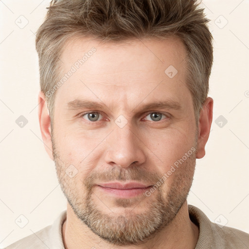 Joyful white adult male with short  brown hair and grey eyes