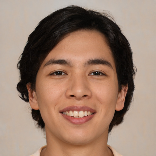 Joyful asian young-adult male with medium  black hair and brown eyes