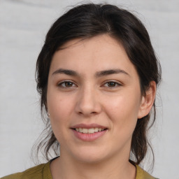 Joyful white young-adult female with medium  brown hair and brown eyes