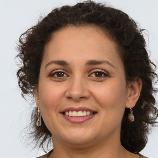 Joyful white adult female with medium  brown hair and brown eyes