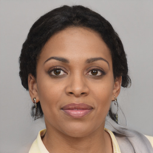 Joyful black young-adult female with medium  brown hair and brown eyes