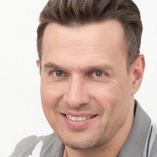 Joyful white adult male with short  brown hair and grey eyes