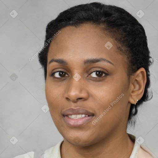 Joyful black young-adult female with short  brown hair and brown eyes