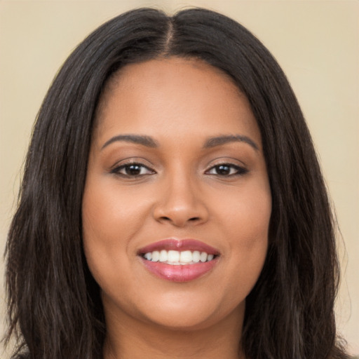 Joyful latino young-adult female with long  black hair and brown eyes