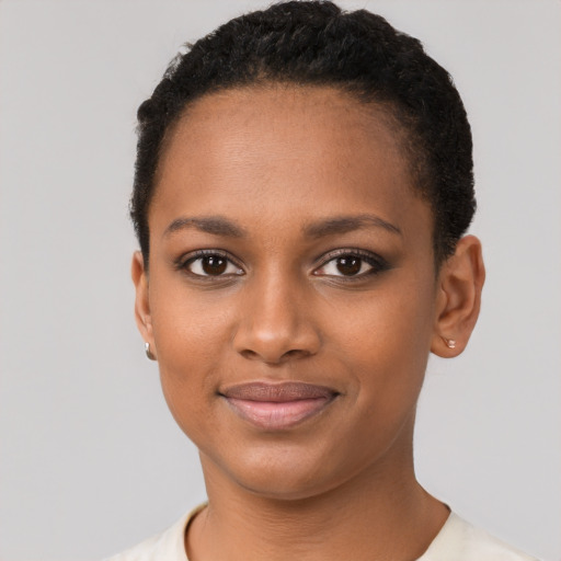 Joyful black young-adult female with short  brown hair and brown eyes