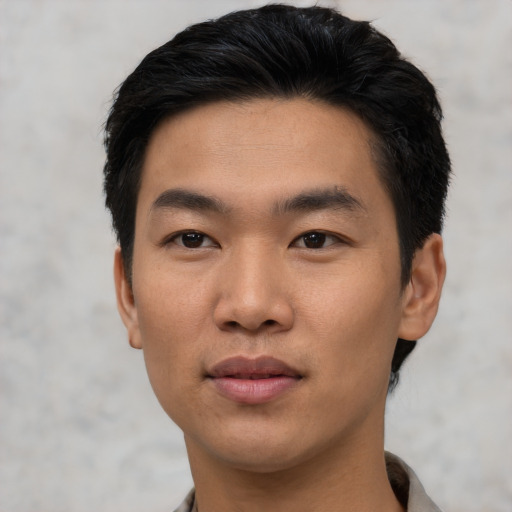 Joyful asian young-adult male with short  black hair and brown eyes