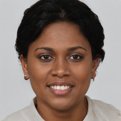 Joyful black young-adult female with short  black hair and brown eyes