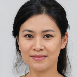 Joyful asian young-adult female with medium  brown hair and brown eyes