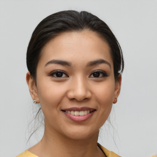 Joyful latino young-adult female with short  brown hair and brown eyes