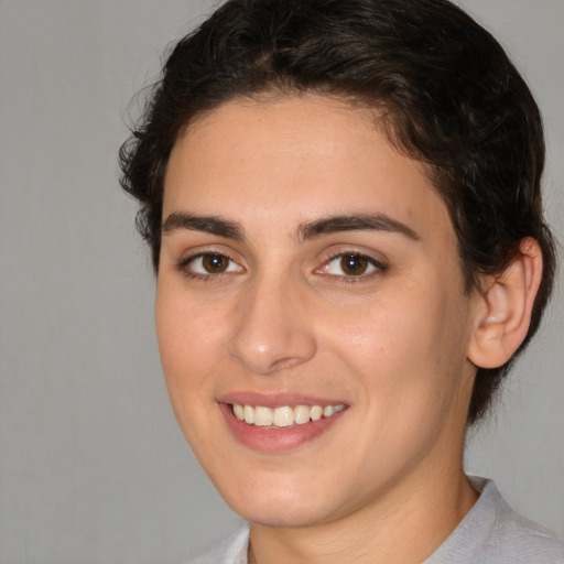 Joyful white young-adult female with medium  brown hair and brown eyes