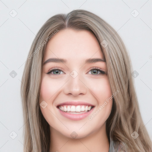 Joyful white young-adult female with long  brown hair and blue eyes