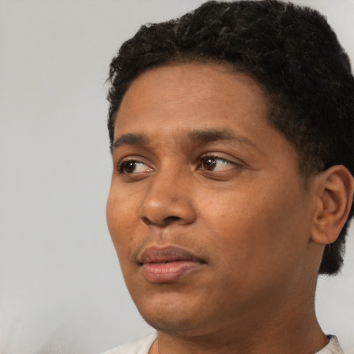 Neutral black young-adult male with short  black hair and brown eyes
