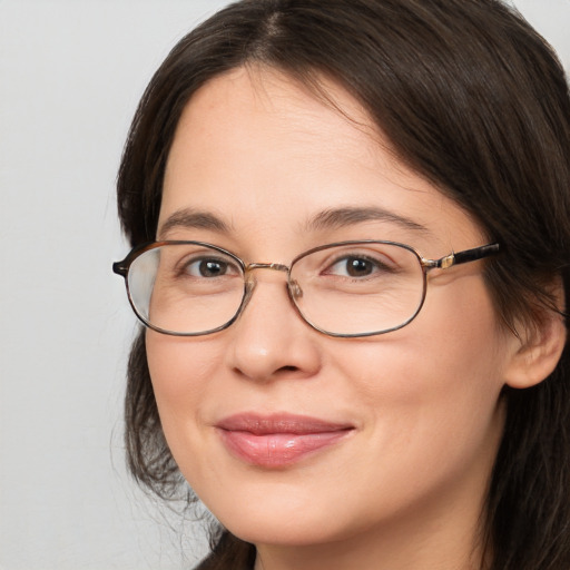 Joyful white adult female with medium  brown hair and brown eyes