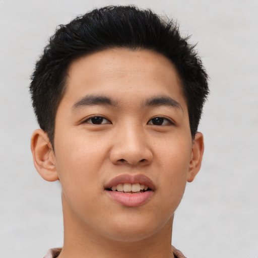 Joyful asian young-adult male with short  brown hair and brown eyes